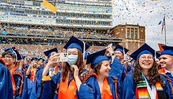 Recent graduates celebrate in cap and gown