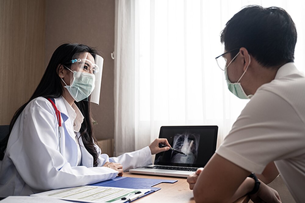 doctor explaining x-ray to a patient