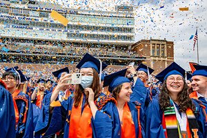 Recent graduates celebrating in cap and gown